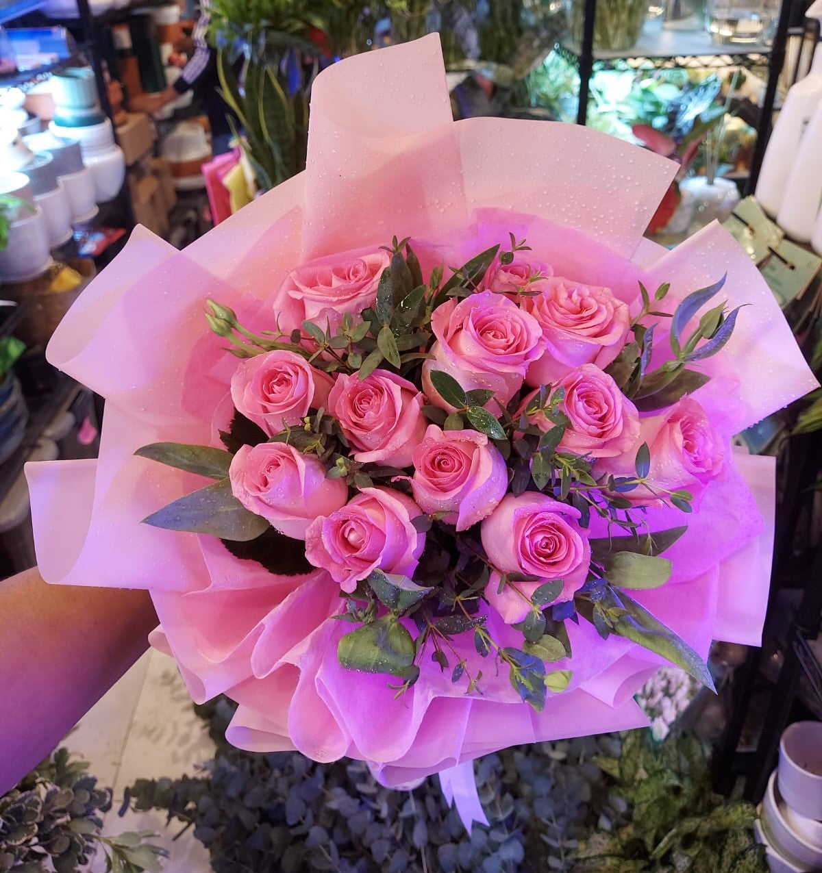 Beautifully arranged 12 roses flower bouquet featuring vibrant red blooms, lush greenery, and decorative wrapping, perfect for gifting.